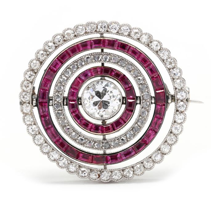   Cartier - Diamond and ruby swivelling target cluster brooch | MasterArt